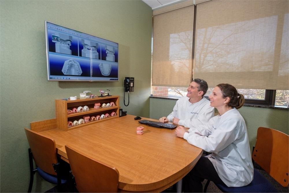 smiling Doctors looking at screen