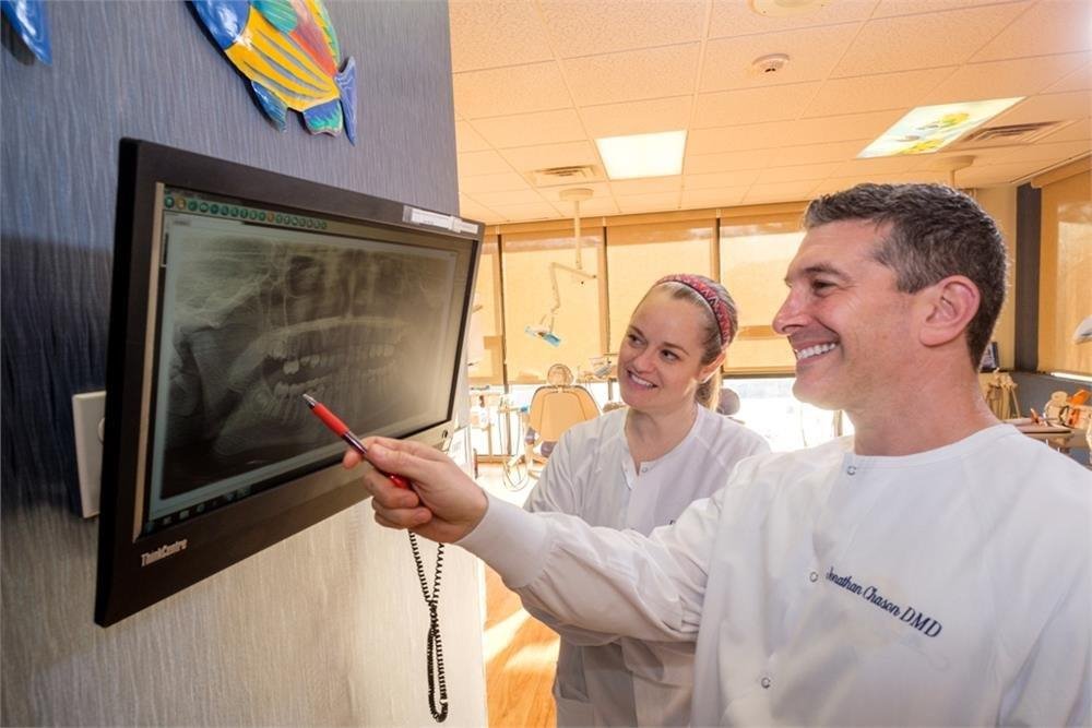 smiling Doctors looking at X-ray on screen