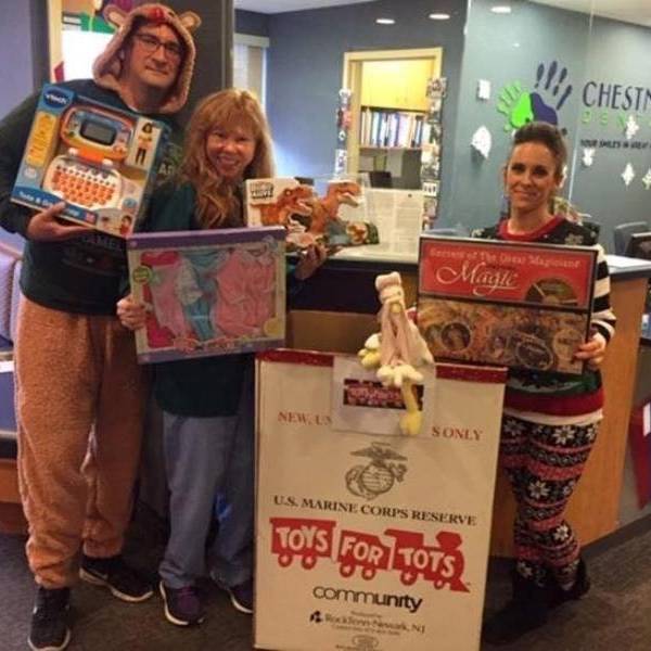 Our Needham office during our Ugly Sweater Day with our office Toys For Tots collection.