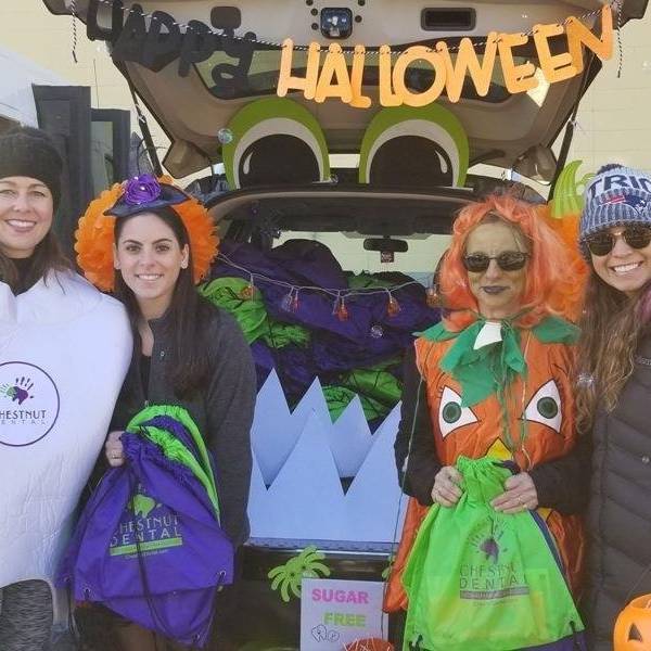 Dr. Katie McCafferty and staff having fun at the Goddard School Trunk or Treat in Bedford.