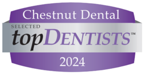 Purple and silver badge with the text: "Chestnut Dental tops the list in topDentists 2024.